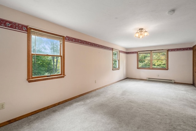 carpeted empty room featuring baseboard heating