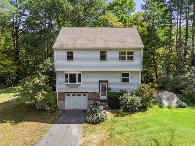 view of front of house with a front yard and a garage