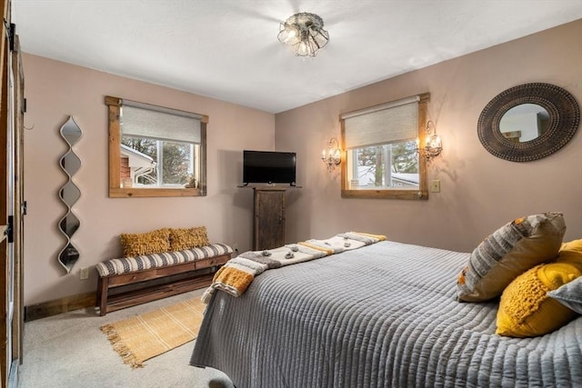 carpeted bedroom featuring baseboards