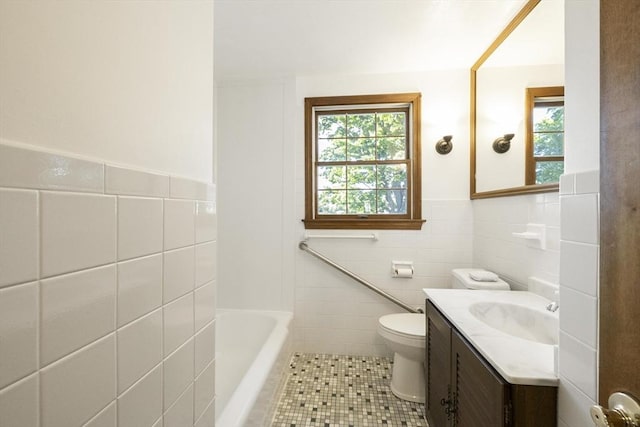 32 Arden St, Holyoke, MA 01040 - full bath featuring tile walls, plenty of natural light, vanity, tile patterned floors, and toilet