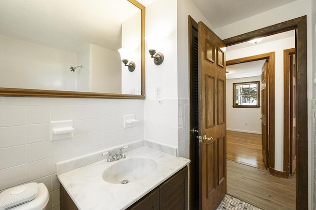 32 Arden St, Holyoke, MA 01040 - bathroom featuring toilet, wood finished floors, vanity, and tile walls