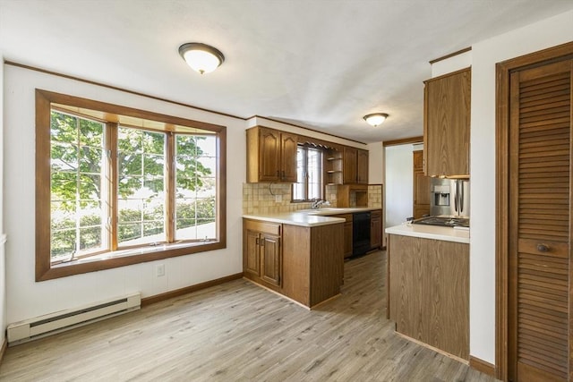 32 Arden St, Holyoke, MA 01040 - kitchen with a baseboard radiator, light wood-type flooring, a peninsula, and light countertops