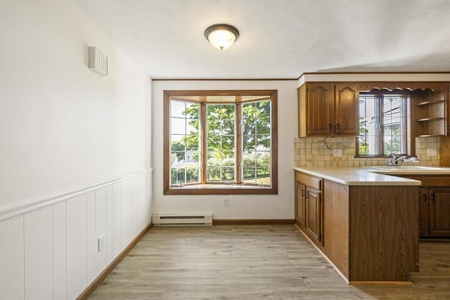 32 Arden St, Holyoke, MA 01040 - kitchen featuring baseboard heating, a sink, light wood-style floors, and light countertops