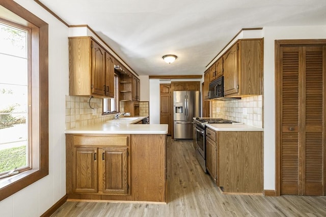 32 Arden St, Holyoke, MA 01040 - kitchen featuring appliances with stainless steel finishes, a sink, healthy amount of natural light, and a peninsula