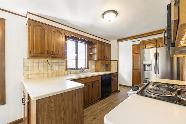 32 Arden St, Holyoke, MA 01040 - kitchen featuring stainless steel appliances, a sink, wood finished floors, backsplash, and a peninsula