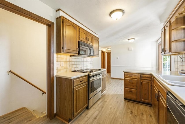32 Arden St, Holyoke, MA 01040 - kitchen featuring stainless steel range with electric stovetop, black microwave, dishwasher, open shelves, and backsplash