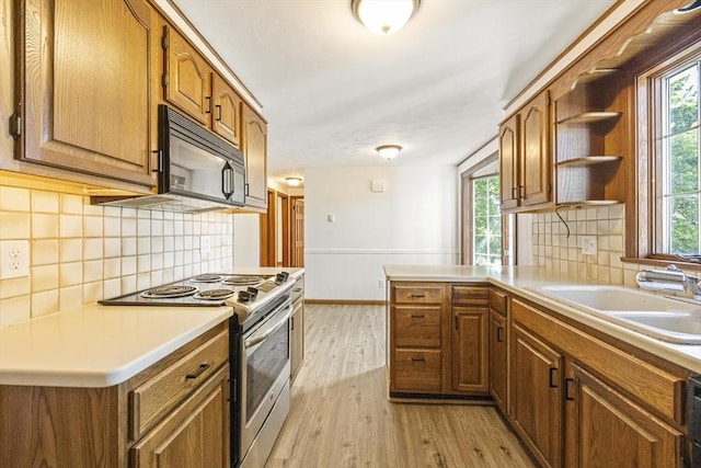 32 Arden St, Holyoke, MA 01040 - kitchen featuring stainless steel range with electric stovetop, black microwave, a sink, light wood finished floors, and open shelves