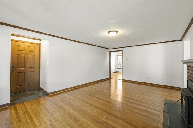 32 Arden St, Holyoke, MA 01040 - unfurnished living room featuring wood finished floors, baseboards, ornamental molding, and a fireplace