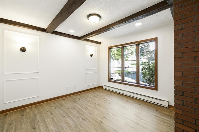 32 Arden St, Holyoke, MA 01040 - spare room featuring baseboard heating, wood finished floors, baseboards, beam ceiling, and a textured ceiling