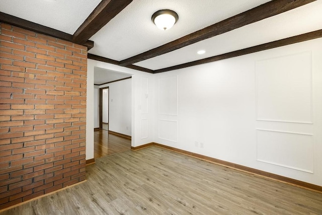 32 Arden St, Holyoke, MA 01040 - unfurnished room featuring light wood-type flooring, beam ceiling, and baseboards