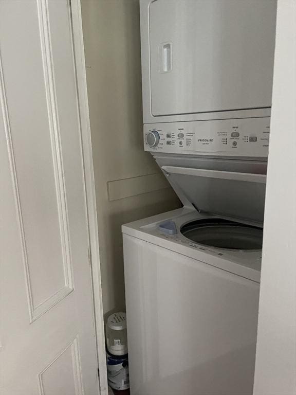 laundry room featuring laundry area and stacked washer / drying machine