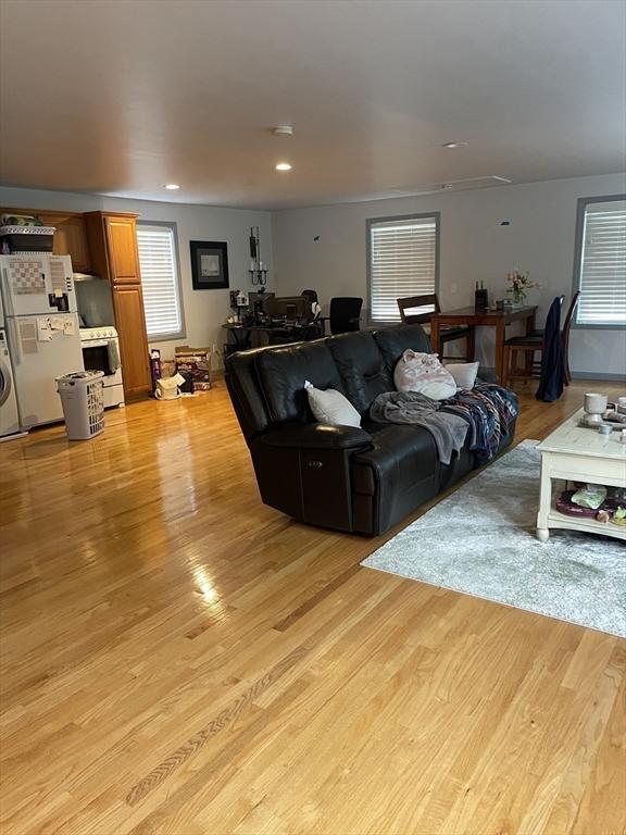 living room with light wood-style floors, recessed lighting, and washer / dryer