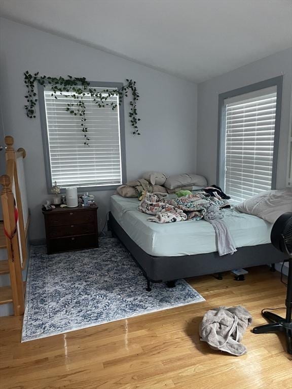 bedroom featuring wood finished floors and vaulted ceiling