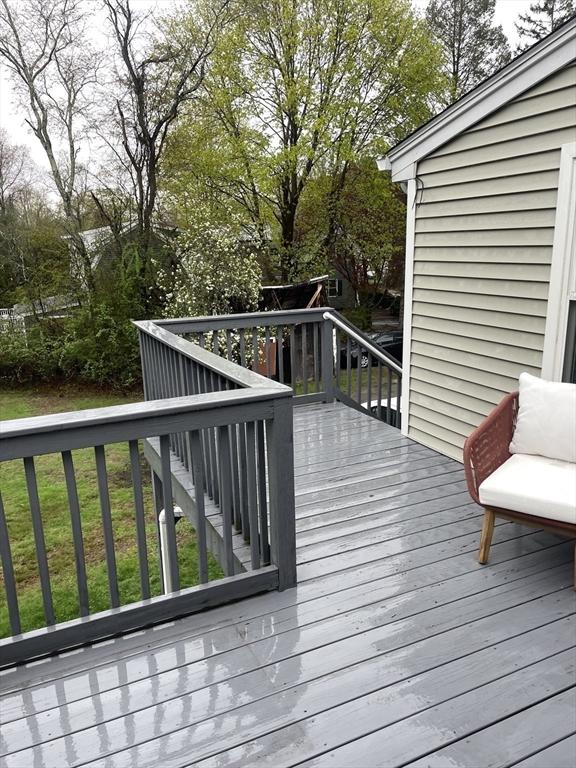 wooden deck featuring a yard