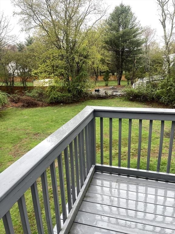 wooden deck with a lawn