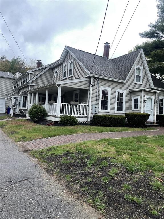 view of front of property featuring a chimney and a porch