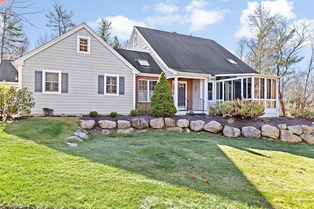 cape cod home with a sunroom and a front lawn