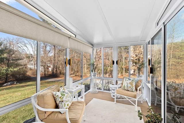 sunroom with plenty of natural light and lofted ceiling