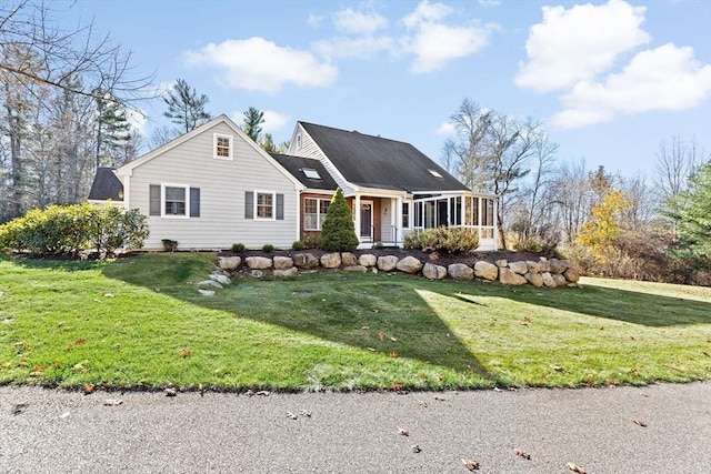 view of front of home featuring a sunroom and a front yard