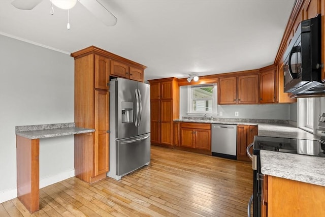 464 Ralph Talbot St, Weymouth, MA 02190 - kitchen with appliances with stainless steel finishes, light wood finished floors, brown cabinetry, a sink, and ornamental molding