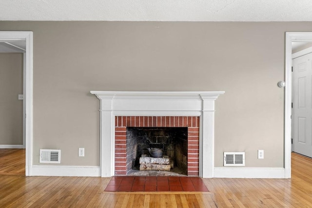 464 Ralph Talbot St, Weymouth, MA 02190 - detailed view of wood finished floors, baseboards, and a brick fireplace