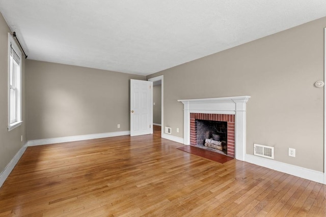 464 Ralph Talbot St, Weymouth, MA 02190 - unfurnished living room with light wood-type flooring, a fireplace, and baseboards
