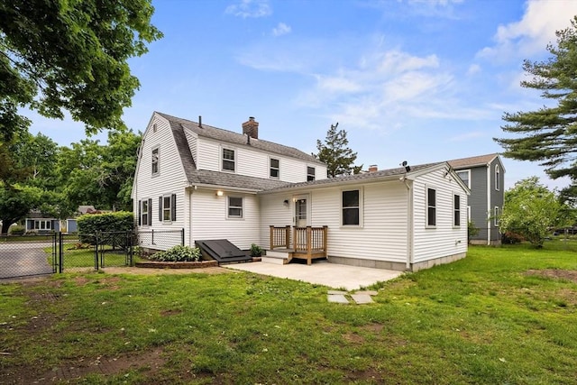 464 Ralph Talbot St, Weymouth, MA 02190 - back of property with a chimney, a gate, a patio area, and roof with shingles