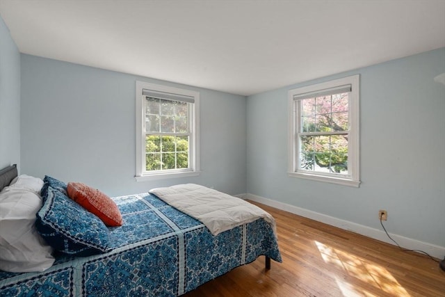 106 Nevada St, Newton, MA 02460 - bedroom featuring baseboards, wood finished floors, and multiple windows