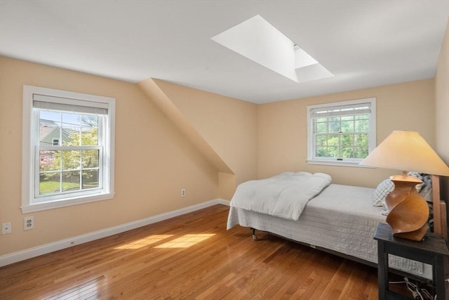106 Nevada St, Newton, MA 02460 - bedroom with a skylight, hardwood / wood-style flooring, and baseboards