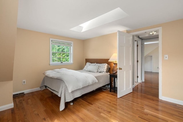 106 Nevada St, Newton, MA 02460 - bedroom featuring a skylight, light wood-style flooring, and baseboards