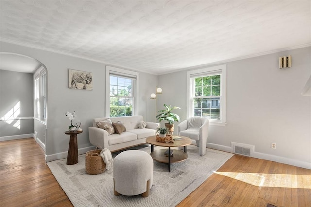 106 Nevada St, Newton, MA 02460 - living room featuring healthy amount of natural light, baseboards, arched walkways, hardwood / wood-style floors, and ornamental molding