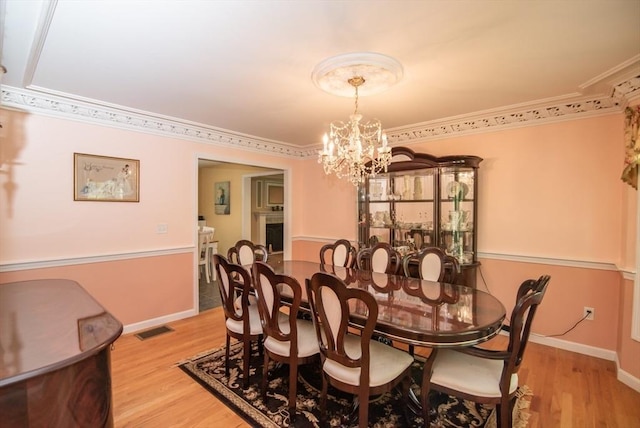 17 Stonepost Rd, Pelham, NH 03076 - dining space featuring a chandelier, light wood-style flooring, baseboards, and crown molding