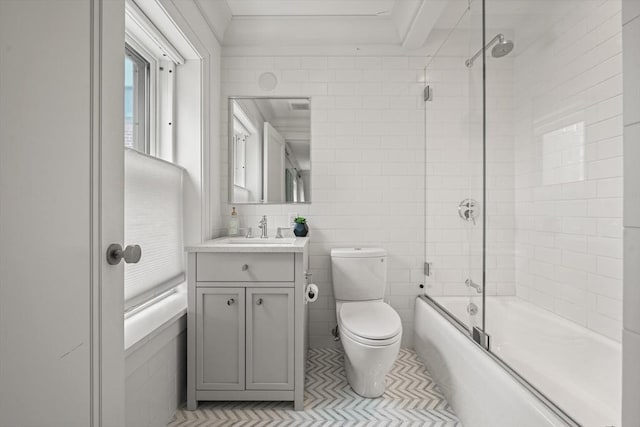 full bath with enclosed tub / shower combo, tile patterned flooring, toilet, vanity, and tile walls