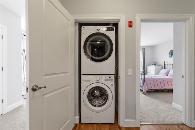 4 Harvest Dr Unit 225, North Andover, MA 01845 - laundry area featuring stacked washer / drying machine, wood finished floors, and carpet