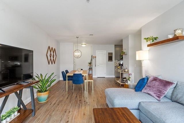 4 Harvest Dr Unit 225, North Andover, MA 01845 - living room featuring light wood-type flooring and a chandelier