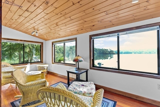 sunroom with lofted ceiling, wooden ceiling, and a water view