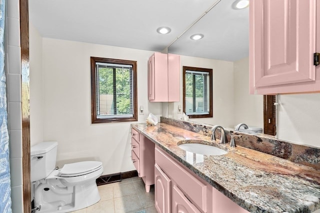 bathroom featuring tile patterned flooring, vanity, and toilet