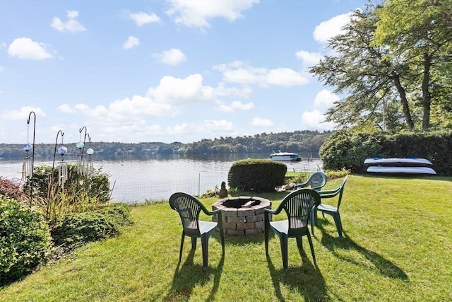 view of yard with a water view and an outdoor fire pit