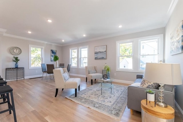 living room with light hardwood / wood-style flooring, plenty of natural light, and crown molding