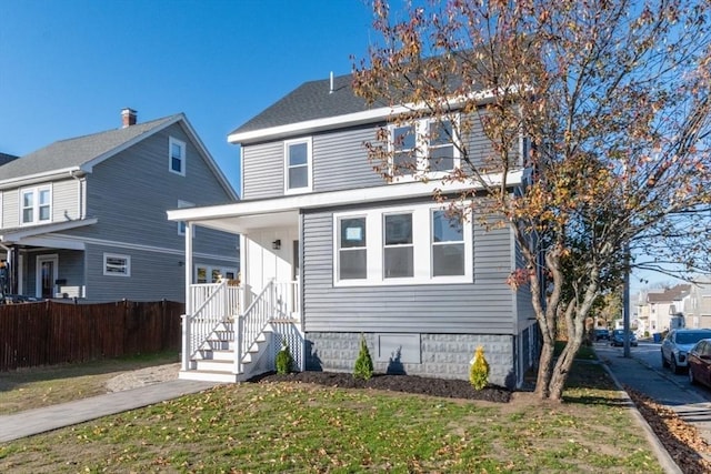 view of property featuring a front lawn