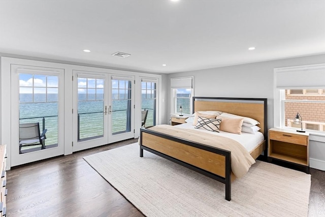 bedroom featuring access to exterior, wood finished floors, visible vents, and recessed lighting