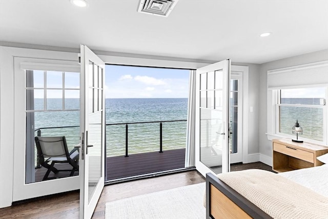 bedroom with a water view, visible vents, baseboards, and recessed lighting