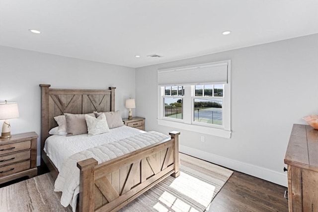 bedroom featuring visible vents, baseboards, recessed lighting, and wood finished floors