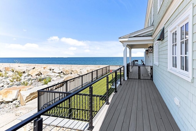 deck featuring a water view and a view of the beach