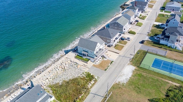 birds eye view of property featuring a water view, a residential view, and a beach view