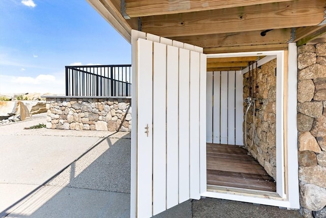 doorway to property featuring board and batten siding and stone siding