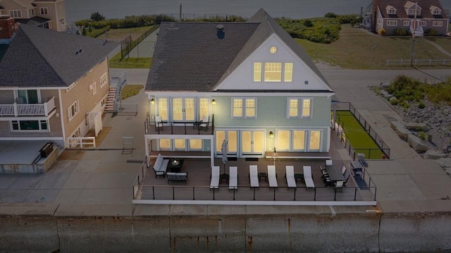 rear view of house featuring a patio area, fence, and stairs