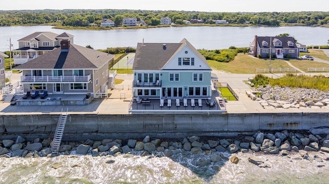 back of house featuring a water view and a balcony