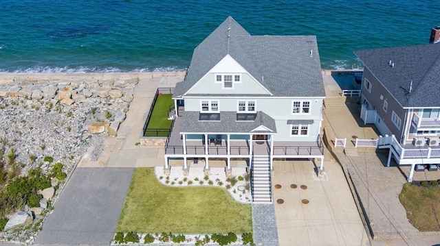 drone / aerial view featuring a water view and a view of the beach