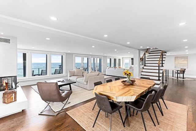 dining area with visible vents, recessed lighting, stairway, and wood finished floors